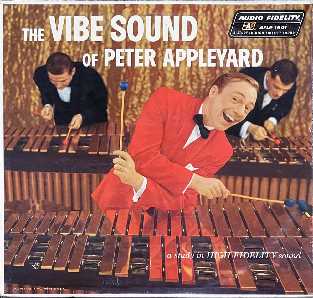 This album cover for "The Vibe Sound of Peter Appleyard" features a lively and colorful design. In the foreground, Peter Appleyard is depicted in a radiant red suit and bow tie, smiling broadly and playfully pointing with a vibraphone mallet. Behind him, two other musicians are shown in formal black attire, each intently playing a vibraphone. The background mimics a textured pattern of brown and gold, enhancing the musical theme. The cover prominently displays the title "The Vibe Sound of Peter Appleyard" and notes such as "a study in HIGH FIDELITY sound" in bold, white typography, along with the label "Audio Fidelity AFDL 1901" and "Printed in U.S.A.," emphasizing the album's quality and production.