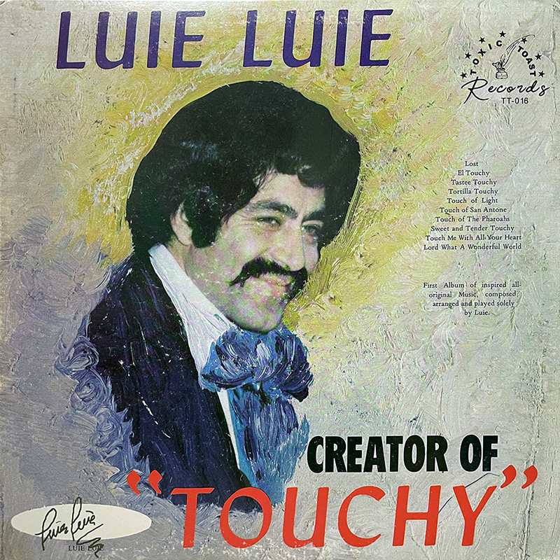 The album cover features a painted portrait of a smiling man with dark, curly hair and a thick mustache, wearing a suit with a large bow tie. The background is textured and painted in a blend of pastel colors, primarily yellow and green. The text at the top reads "LUIE LUIE" in bold, purple letters. Below the portrait, in large black and red letters, is the title "CREATOR OF 'TOUCHY'". The tracklist on the right side of the cover includes titles such as "Lost," "El Touchy," "Tastee Touchy," and others. A note at the bottom right states that this is the first album of inspired all-original music, composed, arranged, and played solely by Luie. The logo for the record label "Toxic Toast Records" is in the top right corner, with the catalog number "TT-016." Additionally, there is a signature logo that reads "Luie Luie" at the bottom left corner.