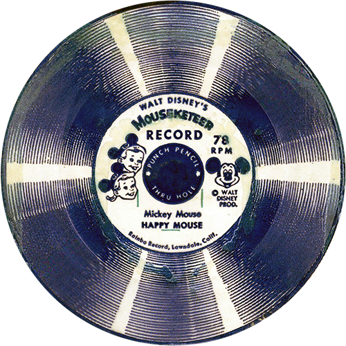 This image is of a vintage Walt Disney’s Mouseketeer Record, a 78 RPM flexi-disc. The label in the center features drawings of a boy and a girl wearing Mickey Mouse ear hats, representing Mouseketeers, and includes a picture of Mickey Mouse. The title of this record is "Happy Mouse," attributed to Mickey Mouse. The record itself has the familiar circular design with alternating light and dark bands, giving it a striped appearance. The label mentions "Punch Pencil Thru Holes" and indicates that it was produced by "Rainbo Records, Lawndale, Calif." This record, like the others, is designed for children to punch through the center for use, likely in a children's phonograph or similar device.