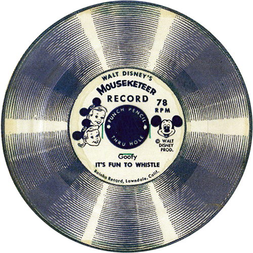 The image is of a vintage Walt Disney’s Mouseketeer Record, specifically a 78 RPM flexi-disc. The label in the center features a Mickey Mouse graphic along with the words “Walt Disney’s Mouseketeer Record.” It also includes a picture of Mickey Mouse and the text "Goofy - It's Fun to Whistle." The record itself has a unique circular design with alternating light and dark bands, giving it a striped appearance. The text also mentions "Punch Pencil Thru Holes" and indicates that it was produced by "Rainbo Record, Lawndale, Calif." The record is intended to be punched through the center for use, likely in a children's phonograph or similar device.