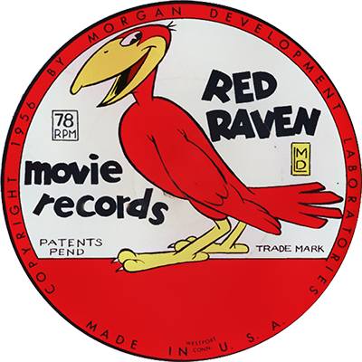 The image is a circular label from a Red Raven Movie Record, a type of children's record from the mid-20th century designed to be played along with a Red Raven Magic Mirror device, which would animate the images printed on the record. The label features a red bird, likely representing the "Red Raven," standing on two yellow feet with a cheerful expression. The text on the label reads "Red Raven" in bold black letters, and "movie records" in a playful font. It also includes "78 RPM" indicating the speed at which the record should be played, and "Patents Pend" and "Trade Mark" in smaller print. The label is surrounded by a red border with the text "Copyright 1956 by Morgan Development Laboratories" at the top and "Made in U.S.A." at the bottom, emphasizing the record's origin and production date.