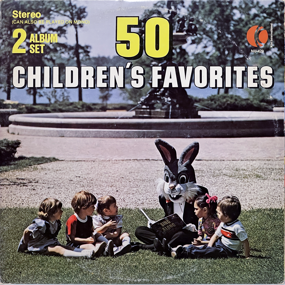 A colorful album cover for "50 Children's Favorites," a 2-album stereo set released by K-tel International. The background shows a sunny park with a fountain and trees. In the foreground, six young children sit on the grass around a person in a giant cartoon rabbit costume, who is dressed in a tuxedo and reading from a songbook titled "Sing Along." Bold yellow and white text dominates the top half of the sleeve. Catalog number NU-429 is printed in the top right corner.